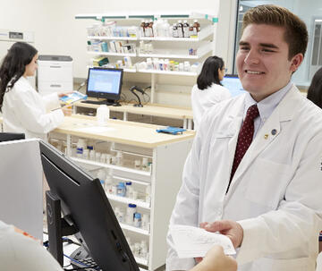 An image of pharmacists working and talking.