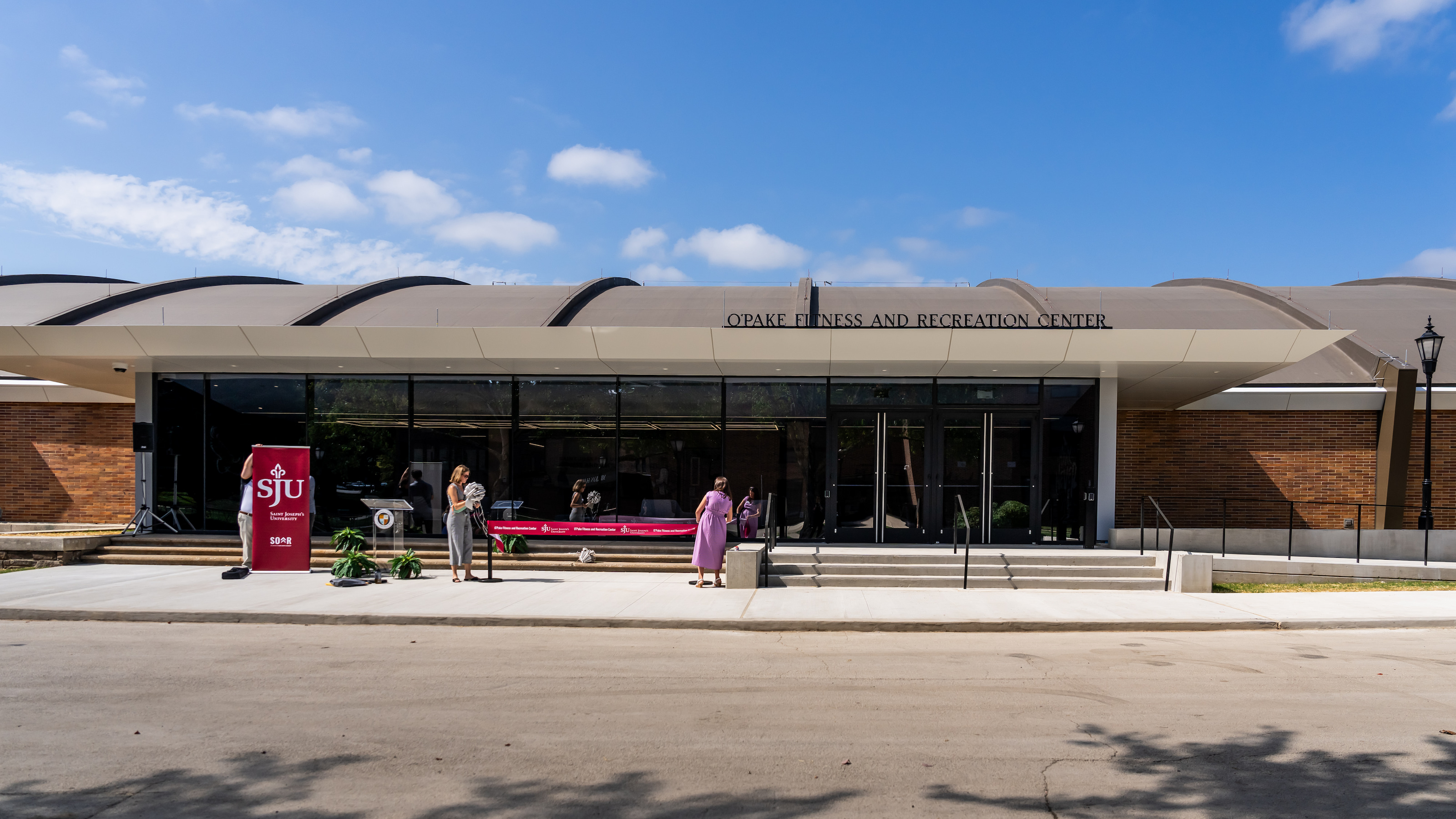 Updated building facade with improved access to the main lobby doors from the exterior and new concrete ADA-accessible ramp.