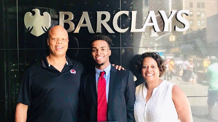 Smith ’20 (center) outside the Barclays New York City office with his parents. 