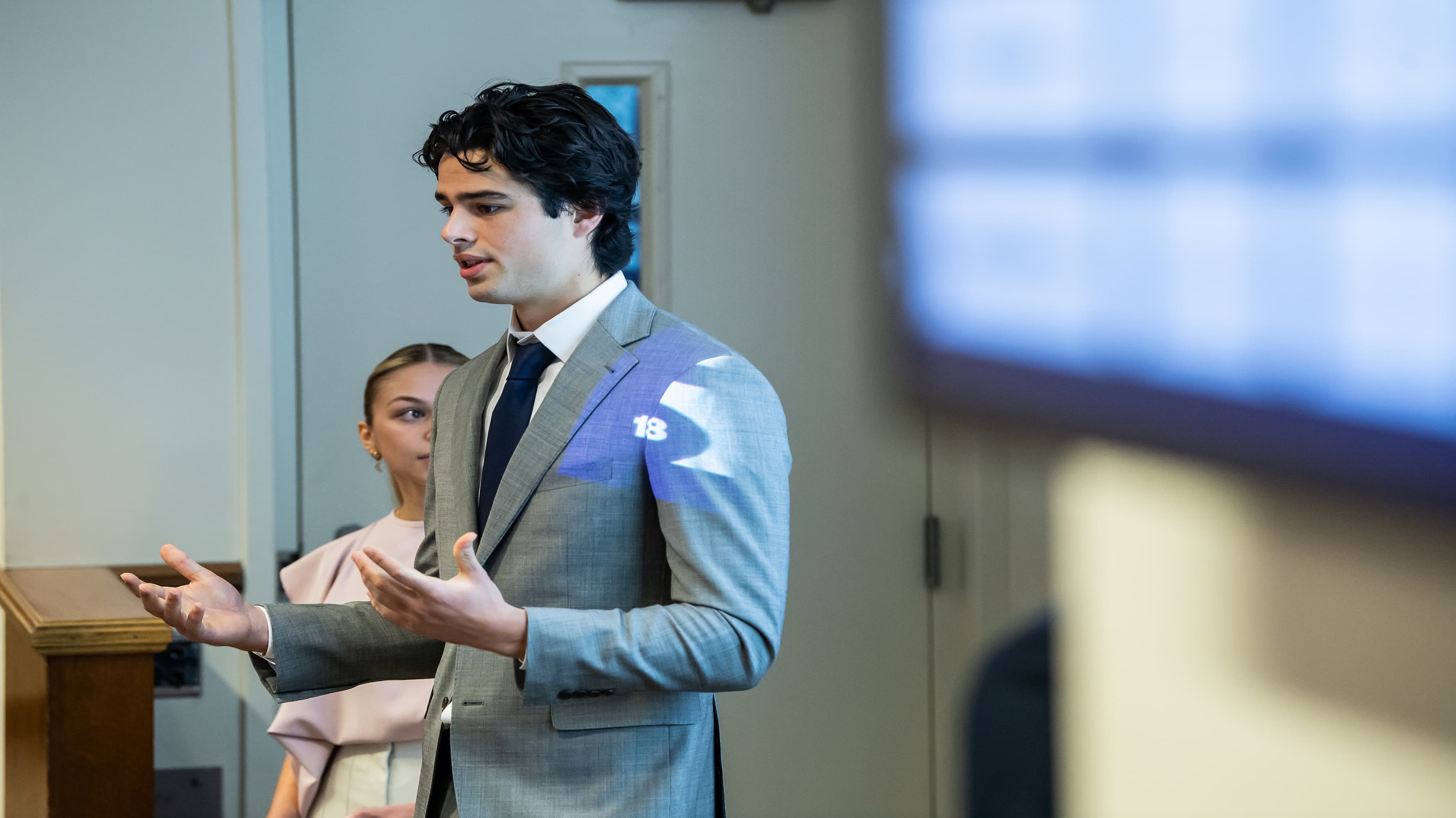 A student presents during a business policy class. 