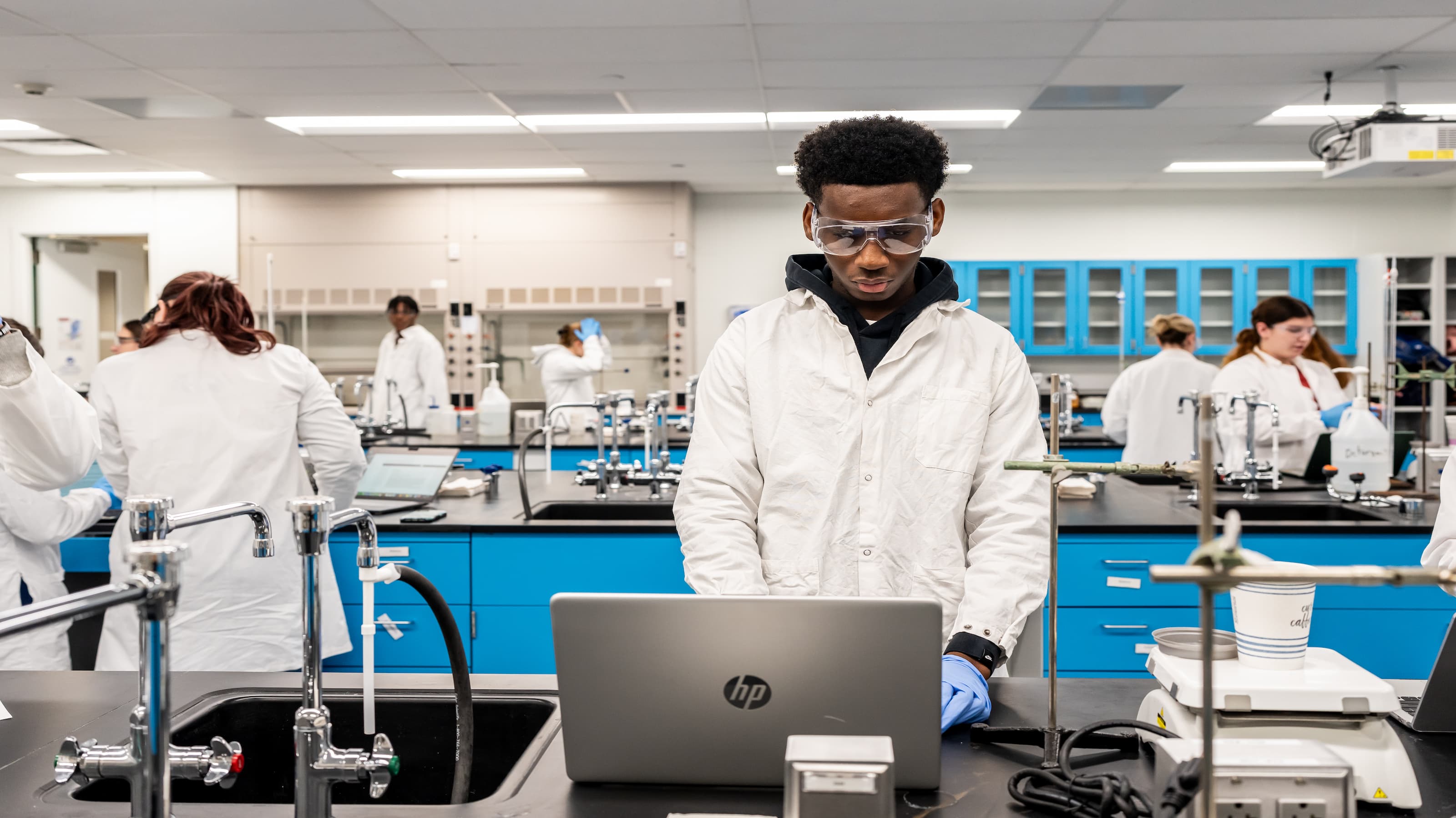 Students conduct experiments in a chemistry lab.