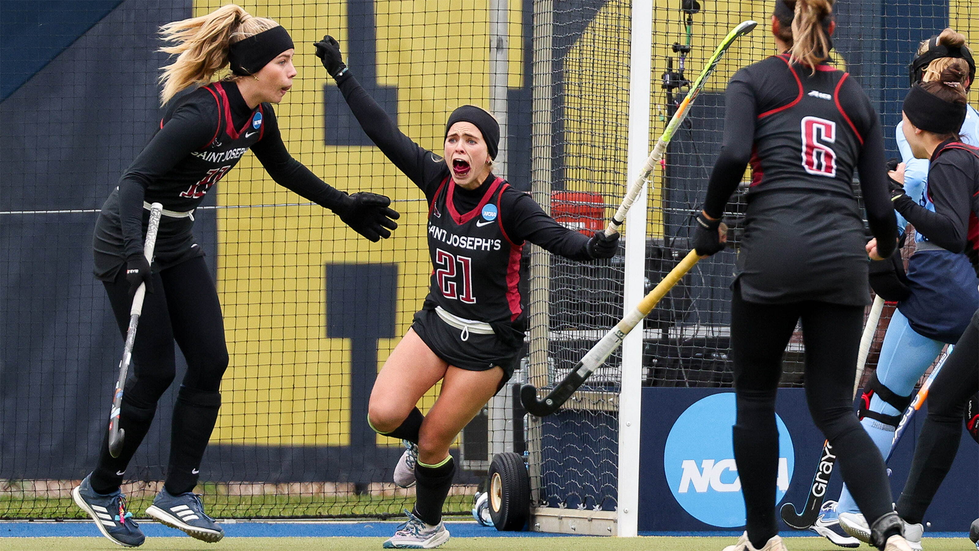 Saint Joseph's field hockey players celebrating on the field