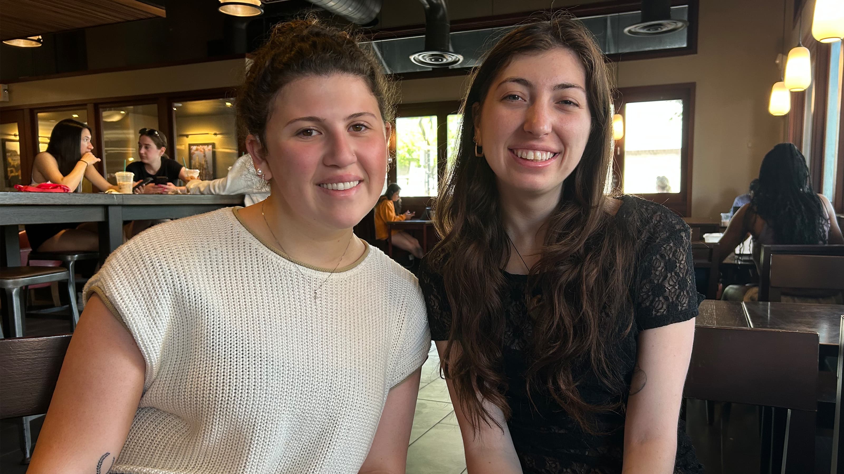 Two female students seated a the campus Starbucks