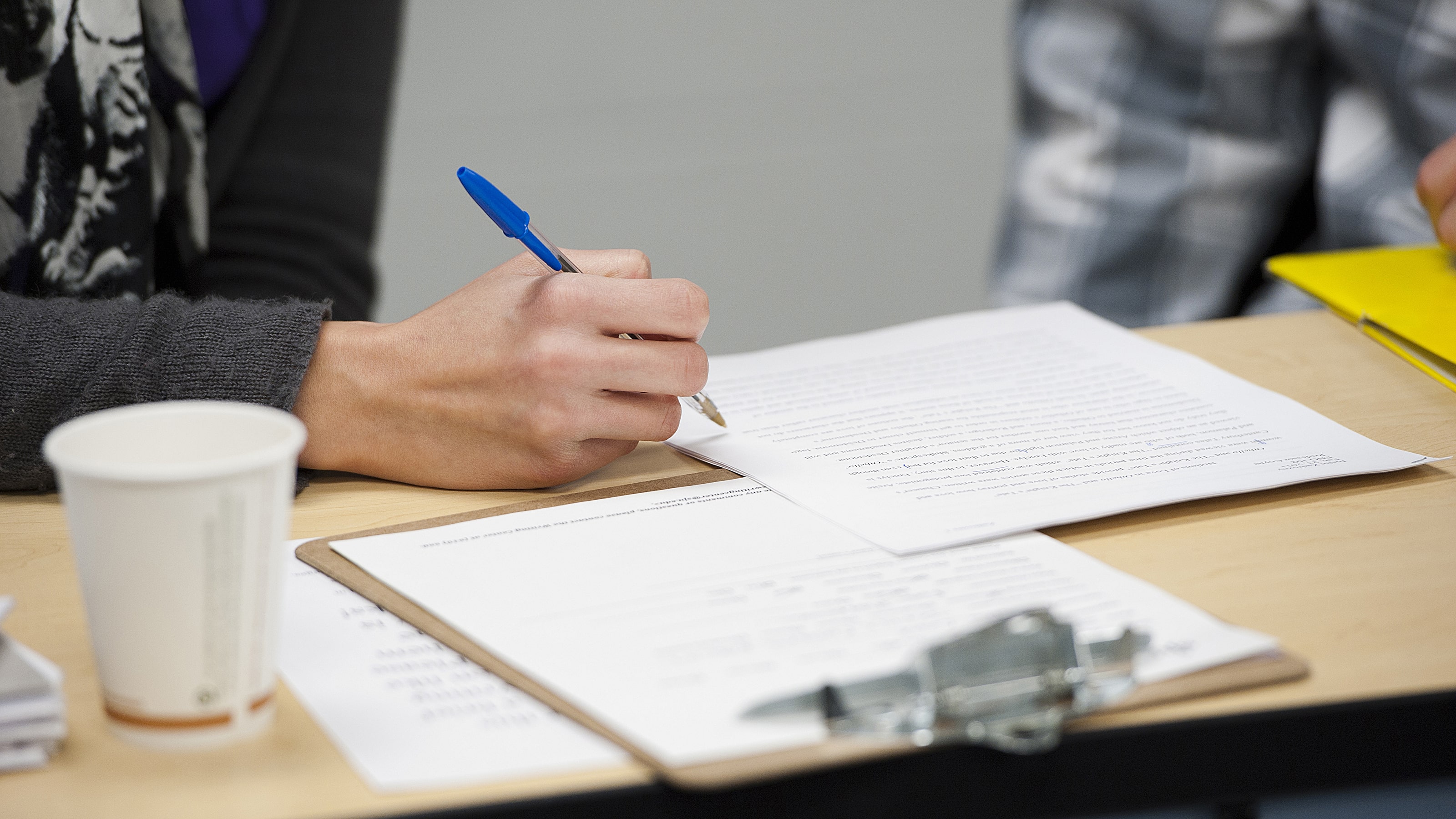 Person using pen to write