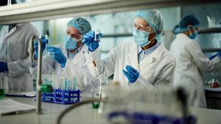 Chemists in a lab performing an experiment.