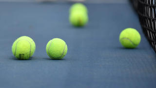 Tennis balls on floor of court