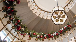 Garland and ornaments decorate a spiral staircase
