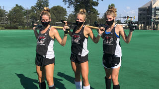 field hockey players on the field during practice.