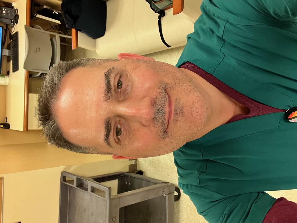 Headshot of Michael J. Jordan in green scrubs in a hospital setting