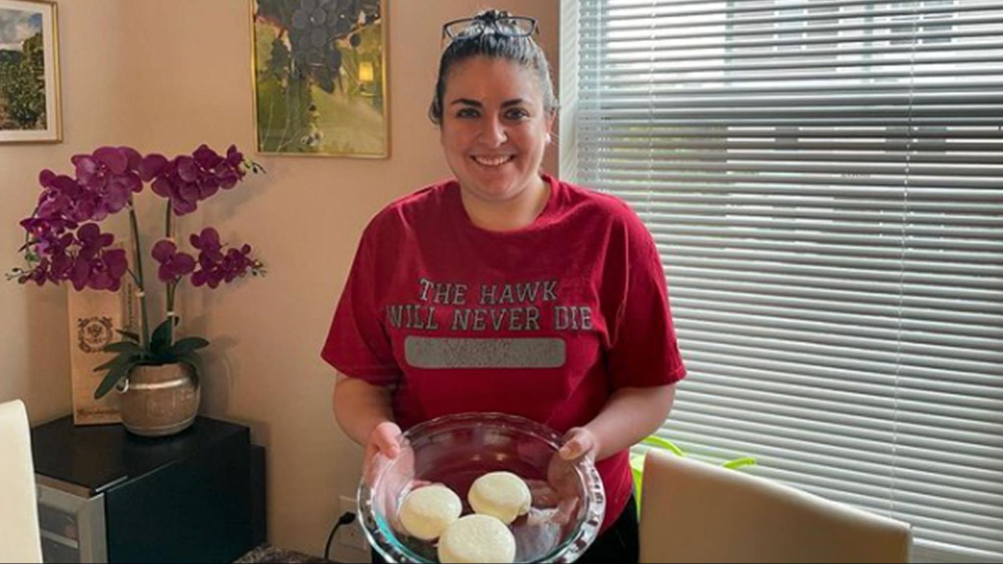 Alumna Ali Corso ’14 holds a plate of mozzarella cheese