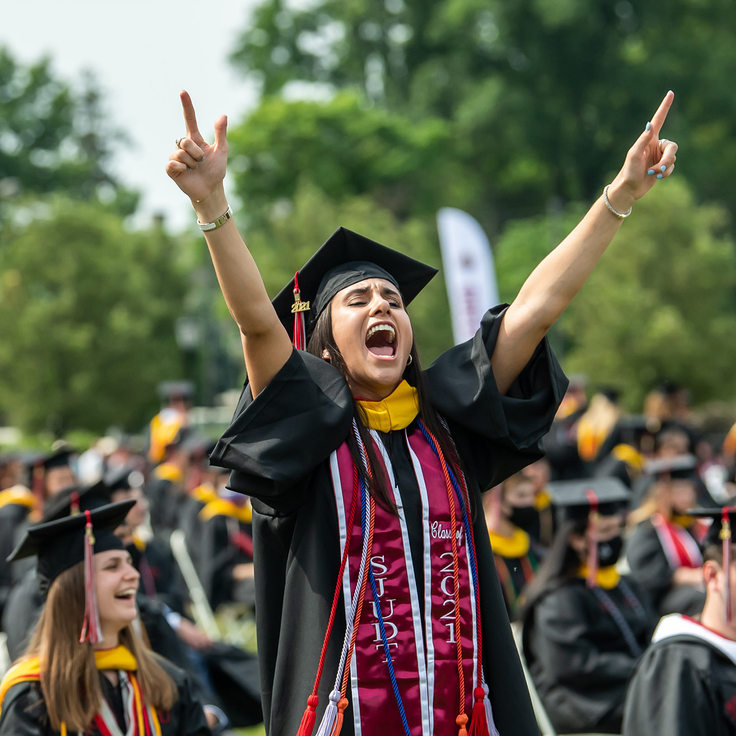 Female undergraduate student at Saint Joseph's commencement celebrating