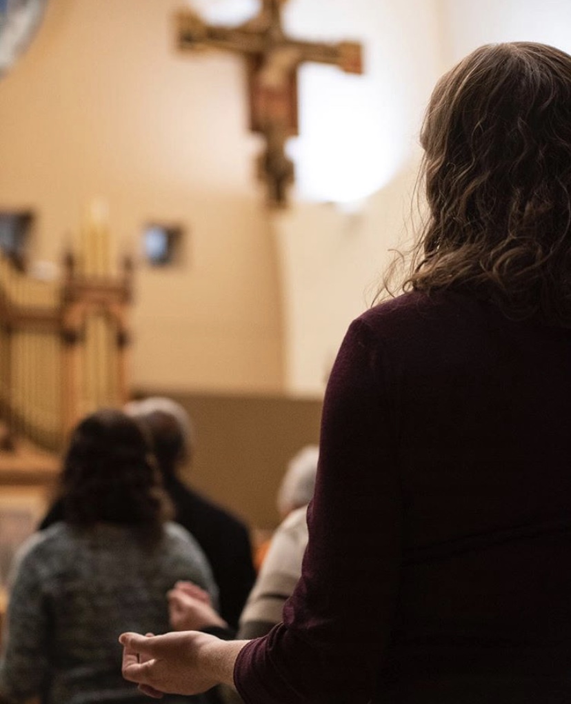 Worshipper in a church with their hands turned upward