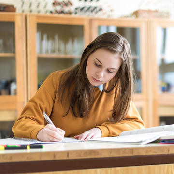 Female student writing in notebook