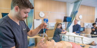 Saint Joseph's University in Lancaster student working on a model in a clinical lab setting