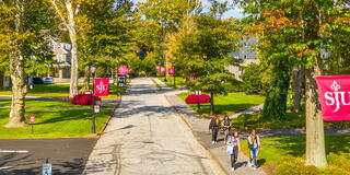 Outdoor aerial of Saint Joseph's University campus with Saint Joseph's flags
