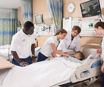 Medical students working on a manikin in Saint Joseph's School of Nursing and Allied Health