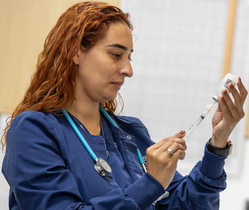 Female nurse filling a syringe