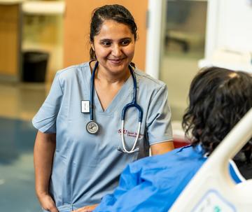 Student in nursing program speaking with a patient