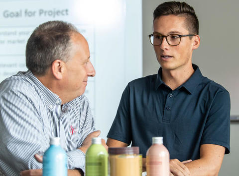 Student and professor talking in a Food Marketing class